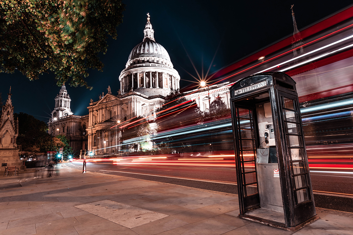 St. Paul's Cathedral at night with light trails and London phone booth.